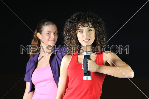two women work out and streaching  in fitness club