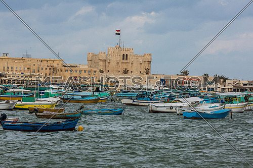 Long Shot outside Citadel of Qaitbay shows fishing boats at day