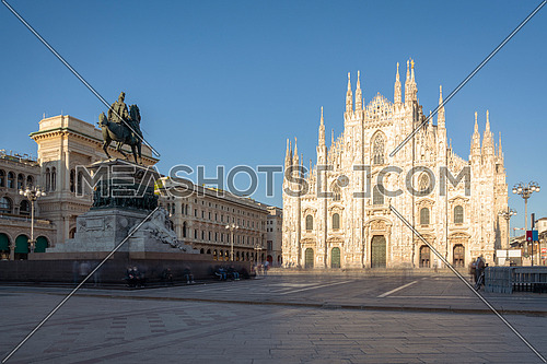 Long exposure of Milan cathedral Duomo and Vittorio Emanuele statue in Square "Piazza Duomo" at sunny day, Milan, Italy.