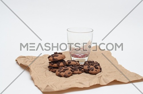 An empty glass and chocolate chips cookies