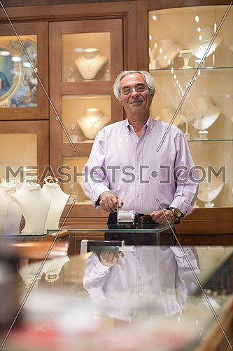 Senior middle eastern successful owner works in his luxury jewelry store