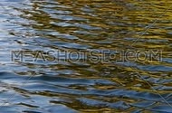 Colorful yellow, red, orange and blue ripples and waves running on water surface, moving flow background, Full HD 1080