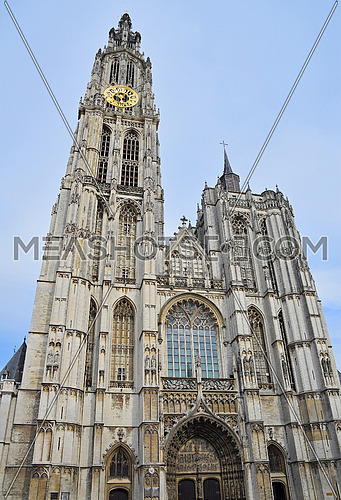 Medieval gothic cathedral of Our Lady in Antwerp, Belgium over clear blue sky, low angle front view