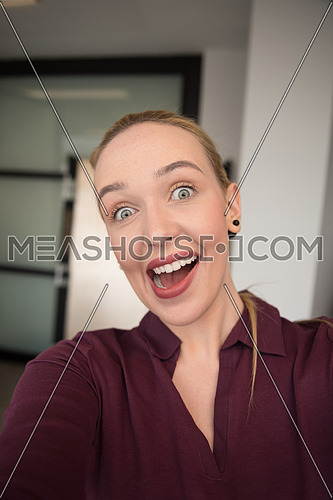 young business woman making selfie and funy surprise face  at office