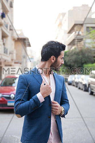 A young business man walking in the street