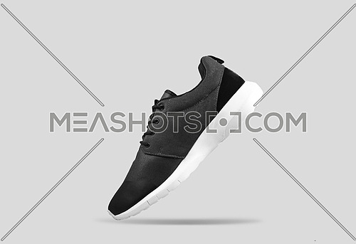 black and silver shoes on grey background