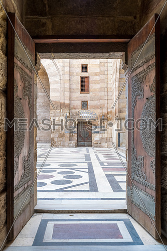 Opened door leading to the courtyard of Al-Sultan Al-Zahir Barquq mosque. Al-Moez Street, Old Cairo, Egypt
