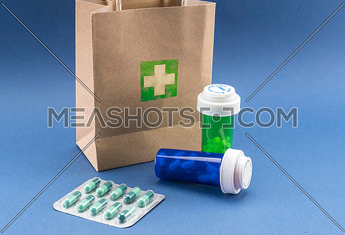 Several medicines with a cardboard bag, conceptual image