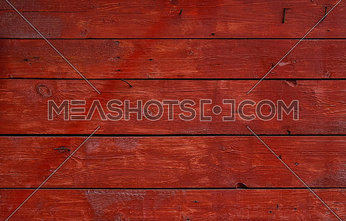 Close up background texture of red vintage weathered painted wooden planks, rustic style wall panel