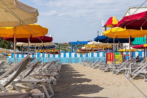 view of Varazze beach and its typical colored sun umbrellas, the parasols are arranged in rows