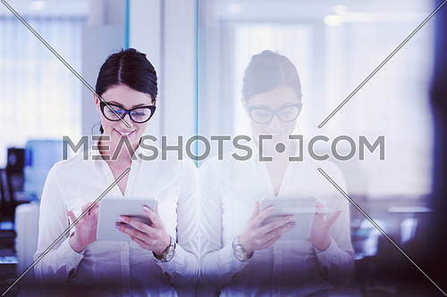Pretty Businesswoman Using Tablet In front of startup Office Interior