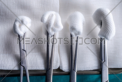 Scissors surgical with torundas in an operating theater, composition horizontal, conceptual image