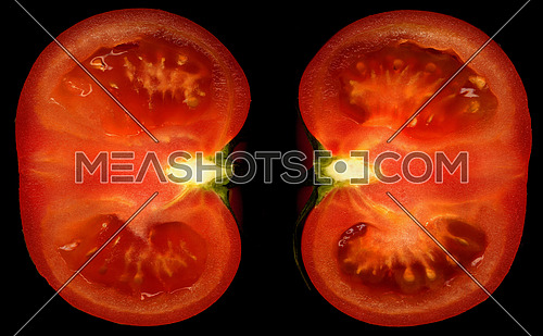 ripe tomato cutted in half on black background