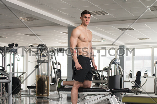 Good Looking And Attractive Young Man With Muscular Body Standing In Gym And Relaxing In Gym