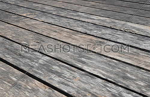 Old vintage rustic aged antique wooden planks floor surface with gaps, diminishing perspective, high angle view