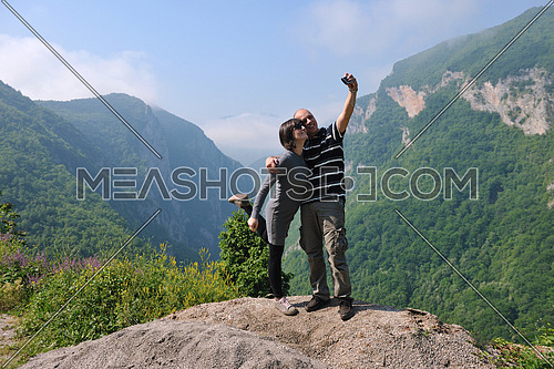 happy young couple in love jump in air in beautiful green and fresh nature
