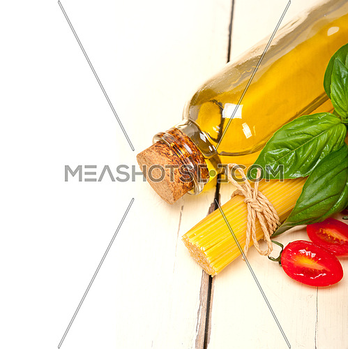 raw ingredients spaghetti pasta tomato and basil foundations of Italian cuisine