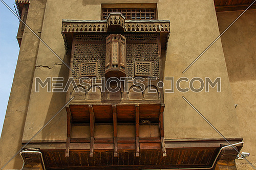 a photo for a historical wooden mashrabeya in old Islamic Cairo , Egypt showing the architecture style used