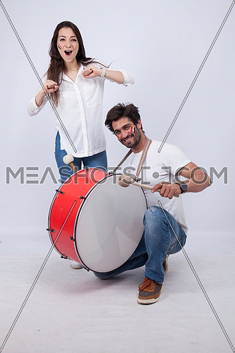 A young couple isolated on white cheering for Egypt