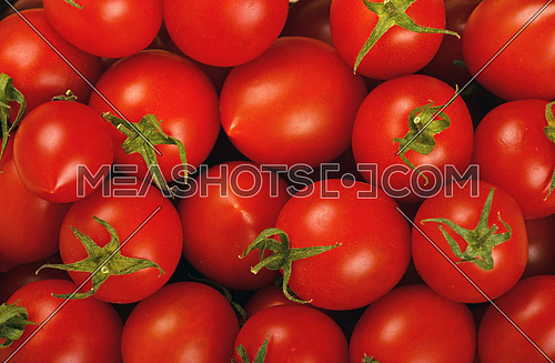 Red ripe fresh small cherry tomatoes background close up
