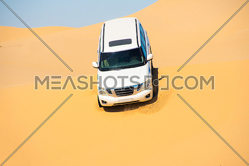 An SUV dune bashing in the desert