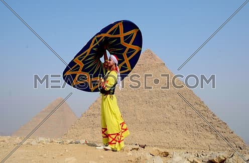 A sufi dancer with Tanoora at giza pyramids