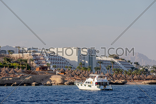 Long shot for yacht sailing showing Sheraton Hotel in Sharm El Shaikh City by day