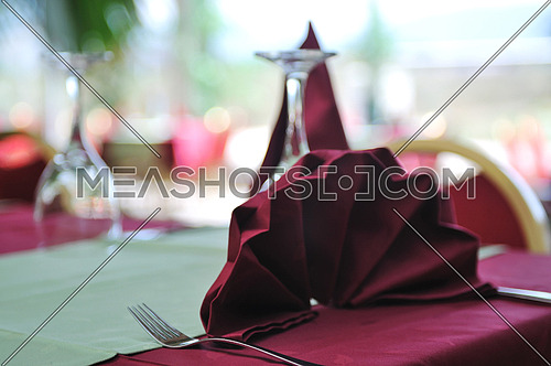 restaurant table with empty wine glass and red table decoration