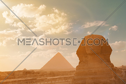beautiful profile of the great sphinx including pyramids of menkaure and khafre in the background