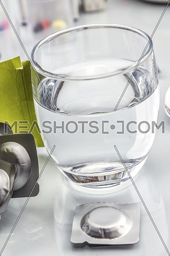 effervescent tablets and glass with water, conceptual image