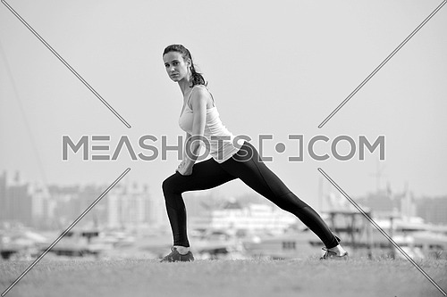 Young beautiful  woman jogging and running  on morning at  park in the city. Woman in sport outdoors health and fitness concept