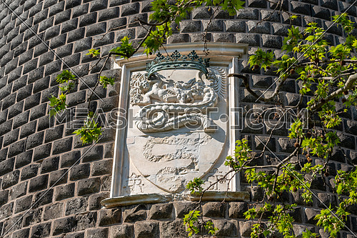 Details of the Sforza Castle (Castello Sforzesco) with the coat of arms of the Visconti noble family with a snake that swallows a human (Biscione). Milan, Italy.