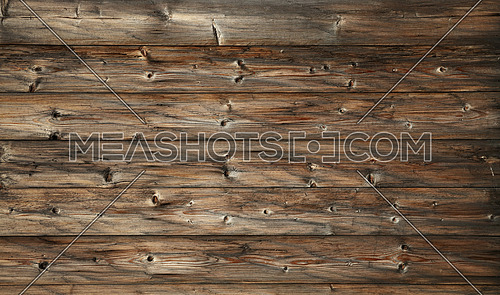 Brown old vintage knotty wooden wide planks wall background texture with aged dark gray and black grunge woodgrain pattern
