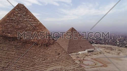 Reveal Shot for The Great Pyramid of Khufu (Cheops) and the top of Menkaure Pyramid at Great Pyramids of Giza Area in Cairo by day.
