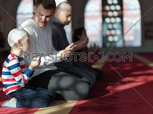 muslim prayer father and son in mosque praying Allah