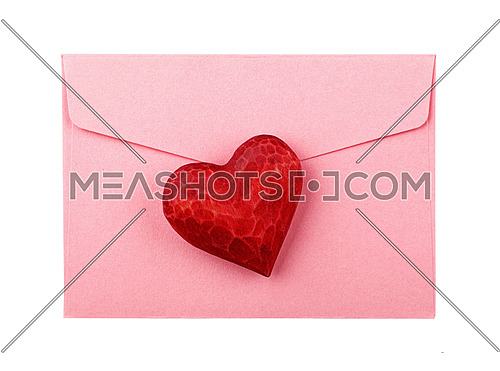 Close up one red painted natural wooden carved heart over pink paper envelope isolated on white background