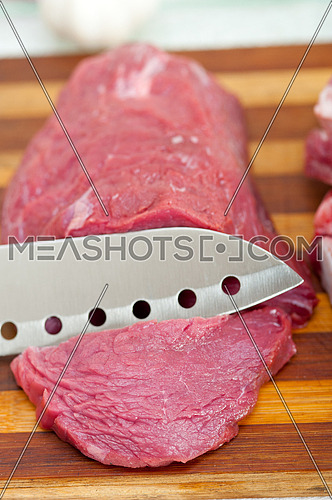 raw beef cutting on wood board ready to cook