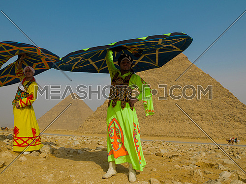 two Egyptian sufi dancers performing at the pyramids