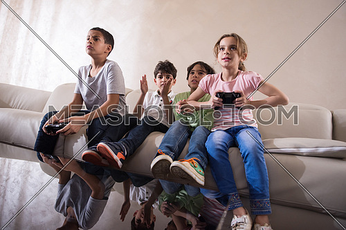 middle eastern children happily play video games and enjoy it with a smile on his face