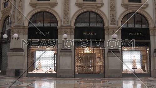 Milan, Italy - June 6, 2021: Prada official shop inside Vittorio Emanuele II gallery, near Duomo Cathedral.