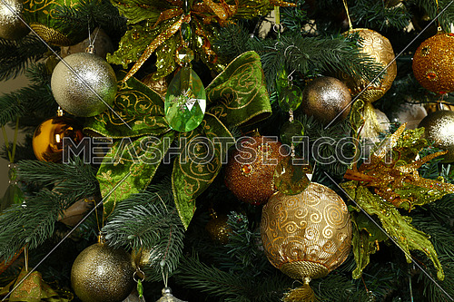 Close up handmade decorations hanging Christmas tree, bows, balls, spheres, front view