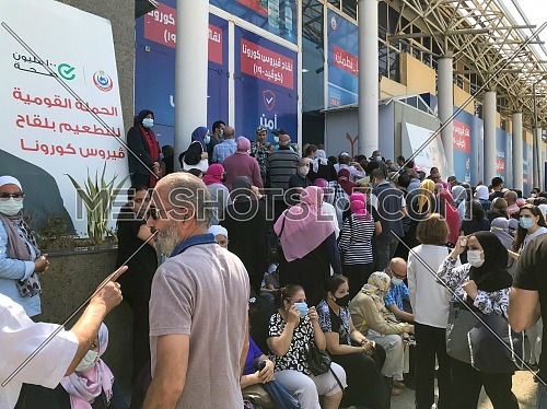 Cairo, Egypt - August 14 2021: Egyptian citizens at Exhibition land waiting for their turn to receive the Covid-19 coronavirus vaccine