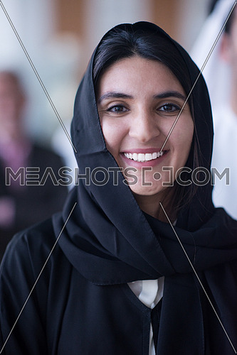 a woman wearing tradition arabian abaya smiling
