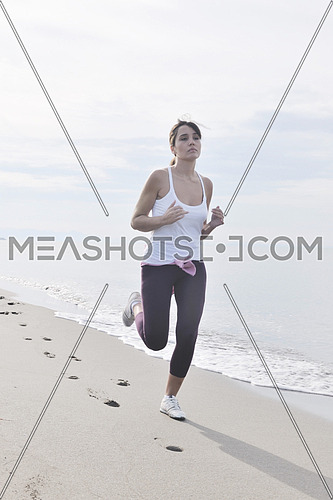 young healthy woman jogging and running at beach at early morning 