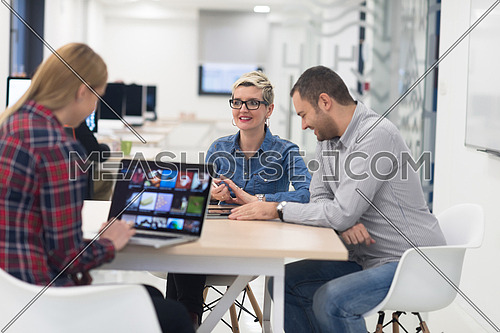 startup business team on meeting in modern bright office interior brainstorming, working on laptop and tablet computer