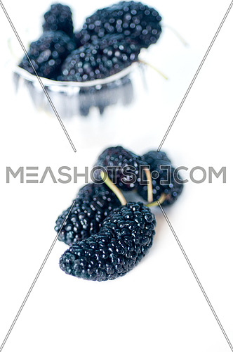 fresh ripe mulberry over white extreme closeup DOF glass bowl on background