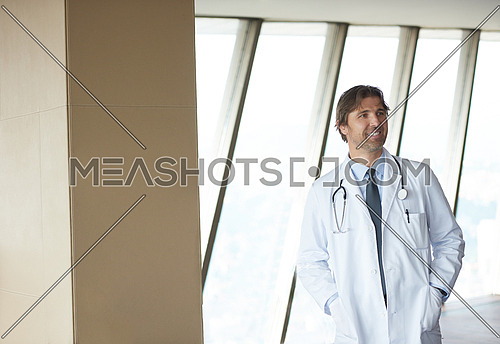 handsome doctor portrait  at modern hospital clinic indoors