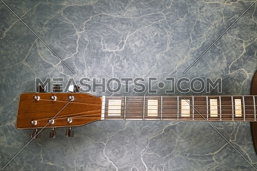 acoustic guitar neck on green marble background,music concept.