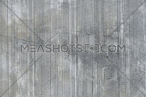 Grey concrete wall with parallel traces from rubbed finish processing abrasive machining and crack check