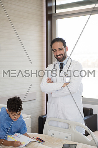 arabian mischievous and beauty kid get treatment by young doctor in modern hospital room